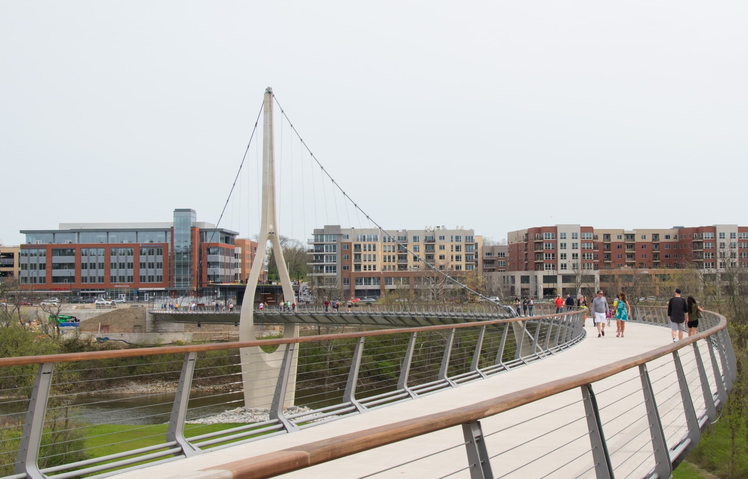The Dublin Link pedestrian suspension bridge over the Scioto River, with the Bridge Park district behind it