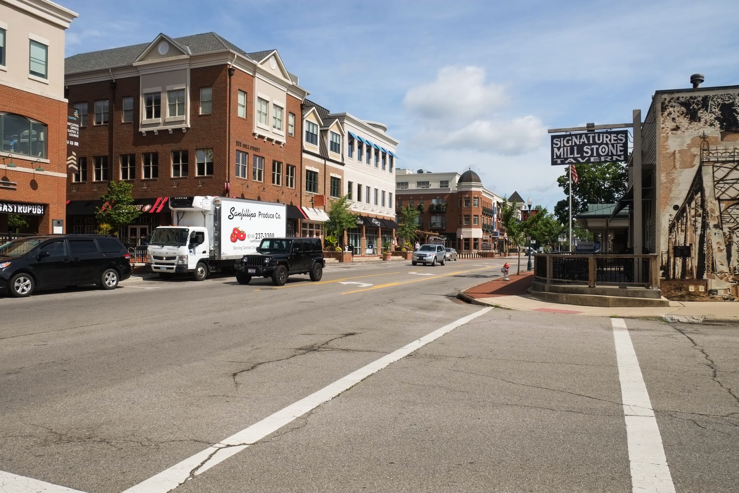 Daytime view down Mill Street in Gahanna's Creekside district with brick buildings and restaurants