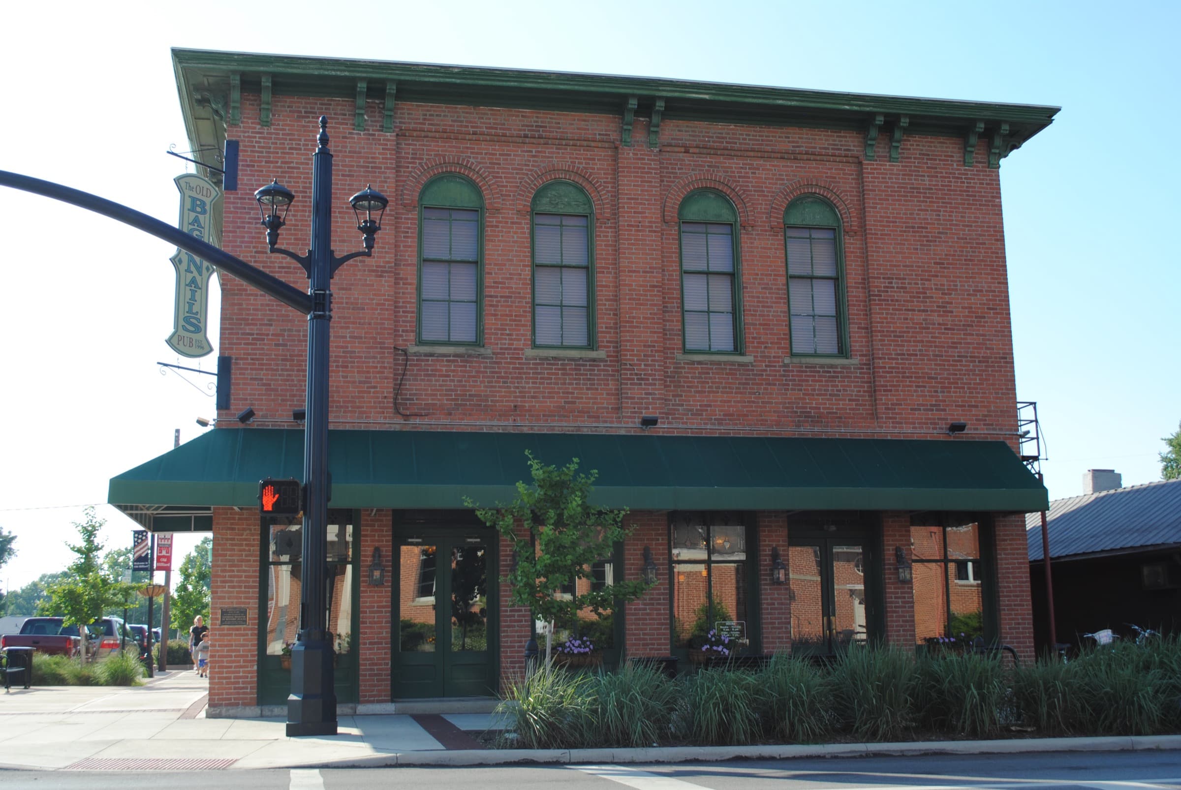 The historic two-story brick Odd Fellows Hall, now a pub, on Main Street in Old Hilliard on a sunny summer day