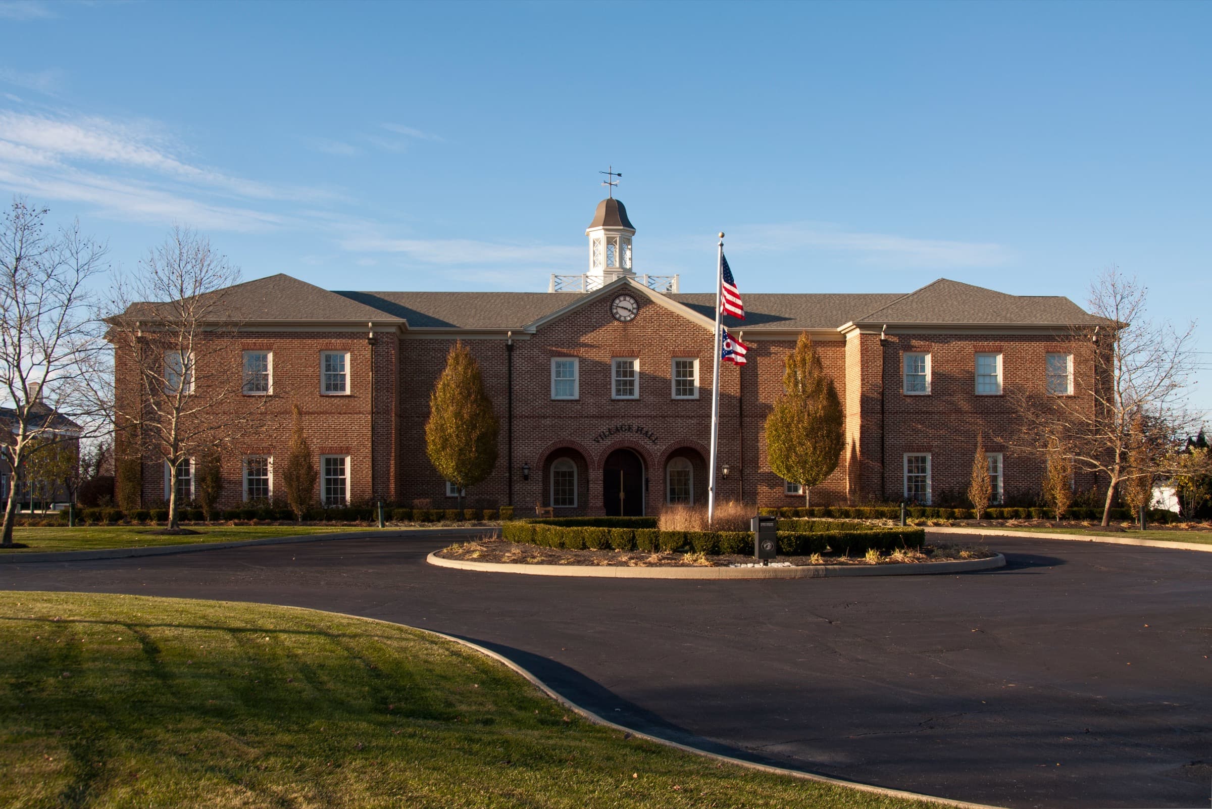 New Albany's red-brick Georgian-style City Hall with white cupola in late-afternoon light