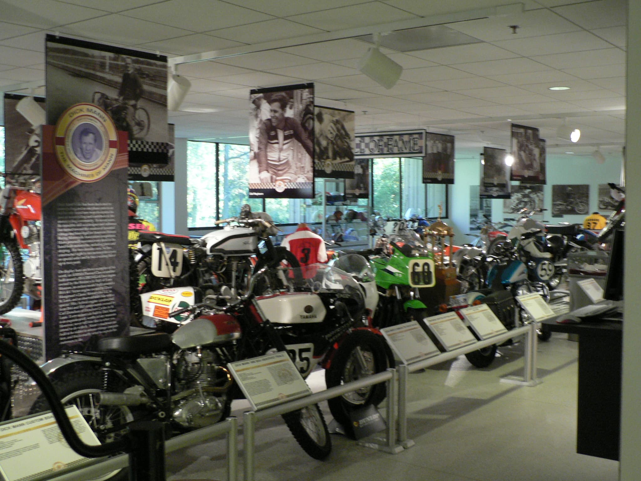 Rows of vintage racing motorcycles on display inside the AMA Motorcycle Hall of Fame Museum