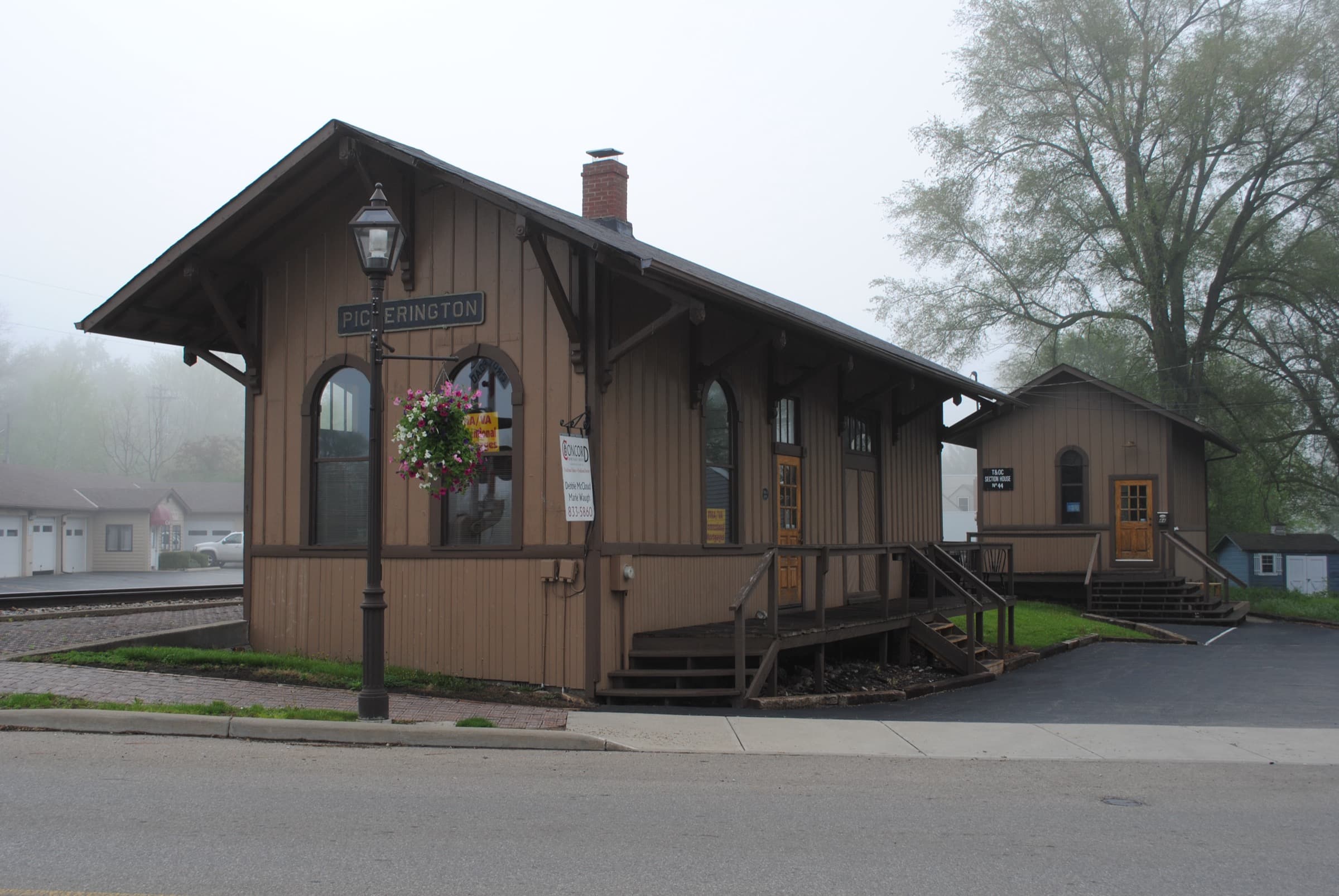 The restored historic Pickerington train depot with lamp post and hanging flower basket in Olde Pickerington Village