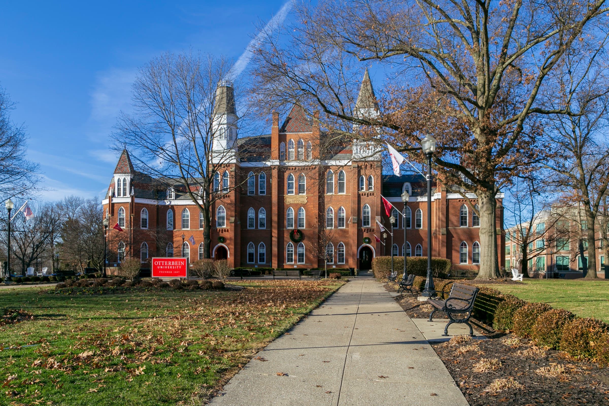 Otterbein University's red-brick Towers Hall from 1872, with its Gothic spires under a blue sky