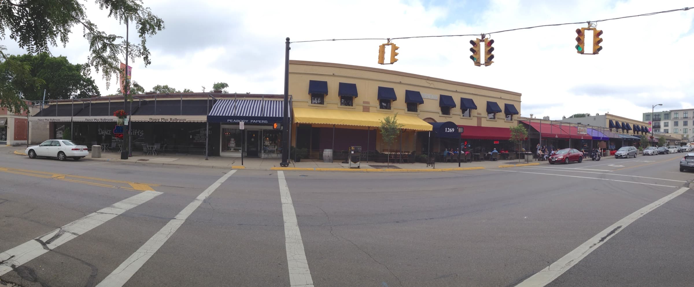 Summer panorama of the historic 1927 Bank Block storefronts and sidewalk patios along Grandview Avenue